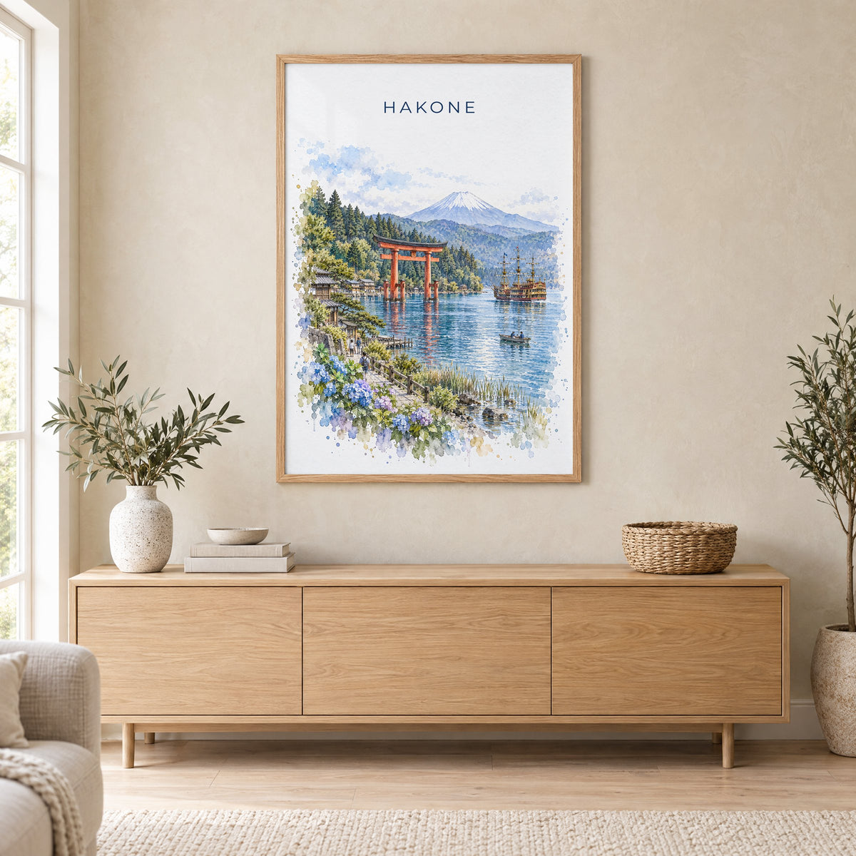 Hakone watercolor print in an oak frame above a light wood sideboard in a Scandinavian living room