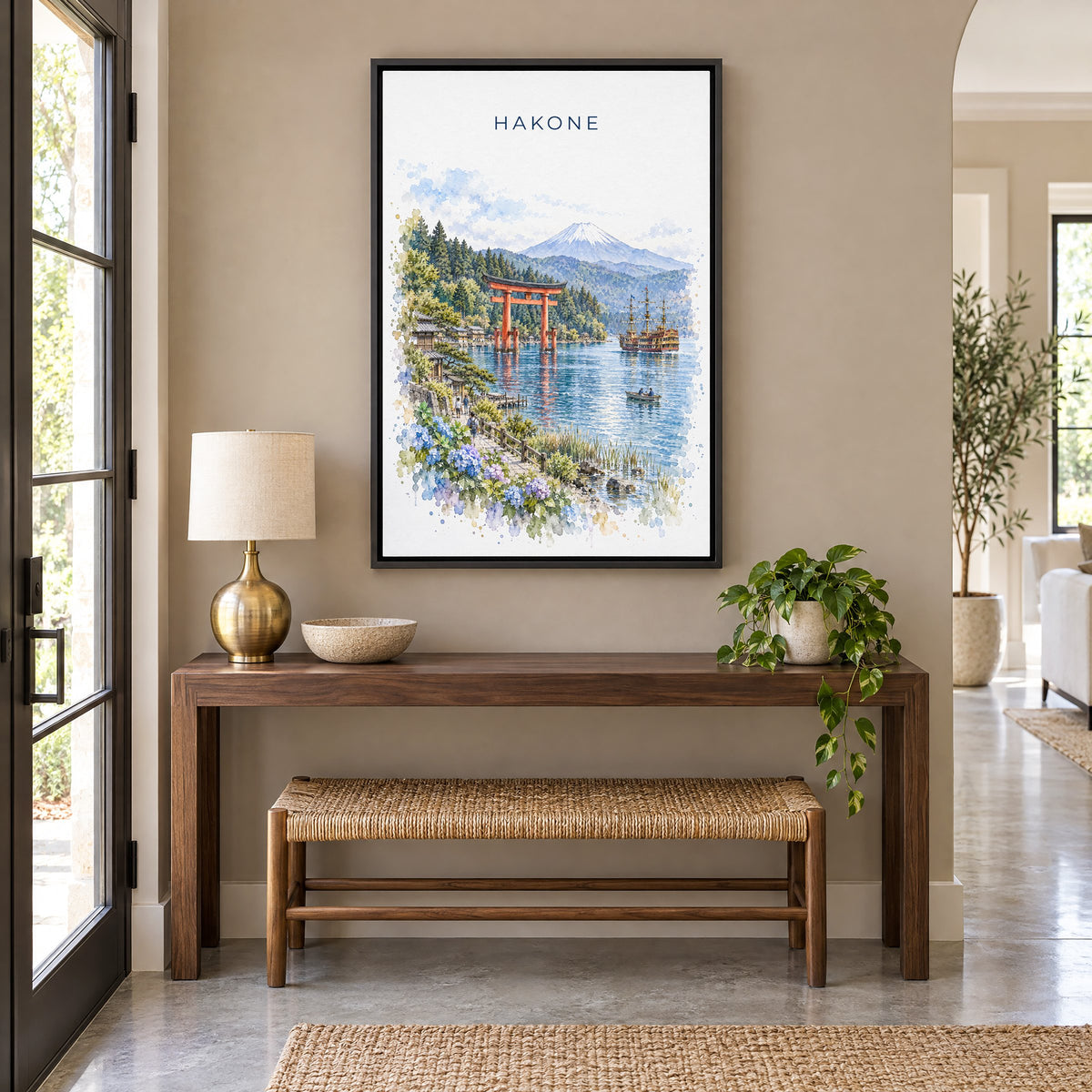Hakone watercolor print as a black floater canvas above a walnut console and woven bench in an entryway