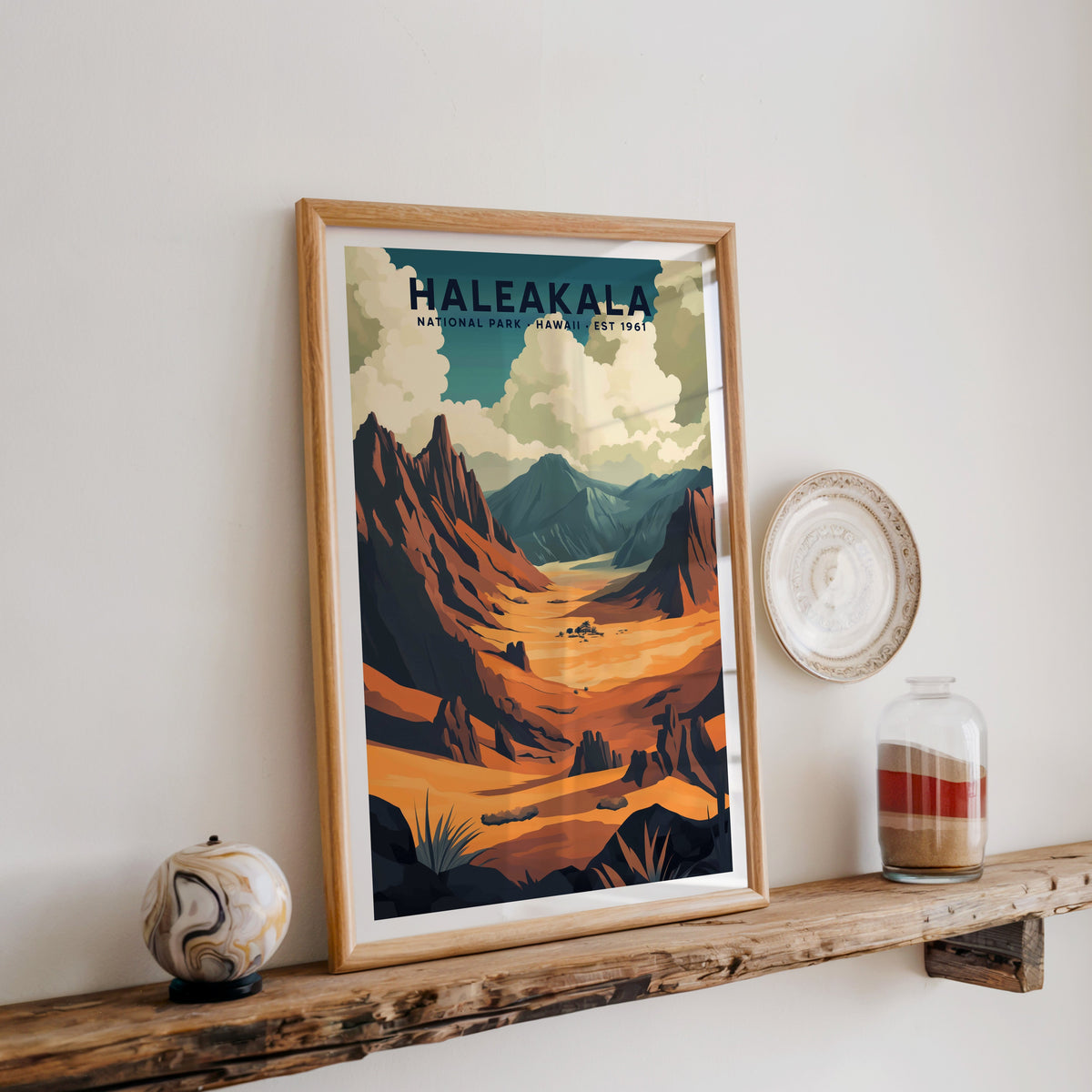 Haleakalā National Park print in an oak frame on a rustic wood shelf with ceramics