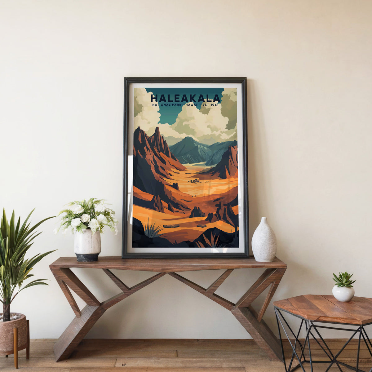 Haleakalā poster in a black frame on an entryway console table with white flowers