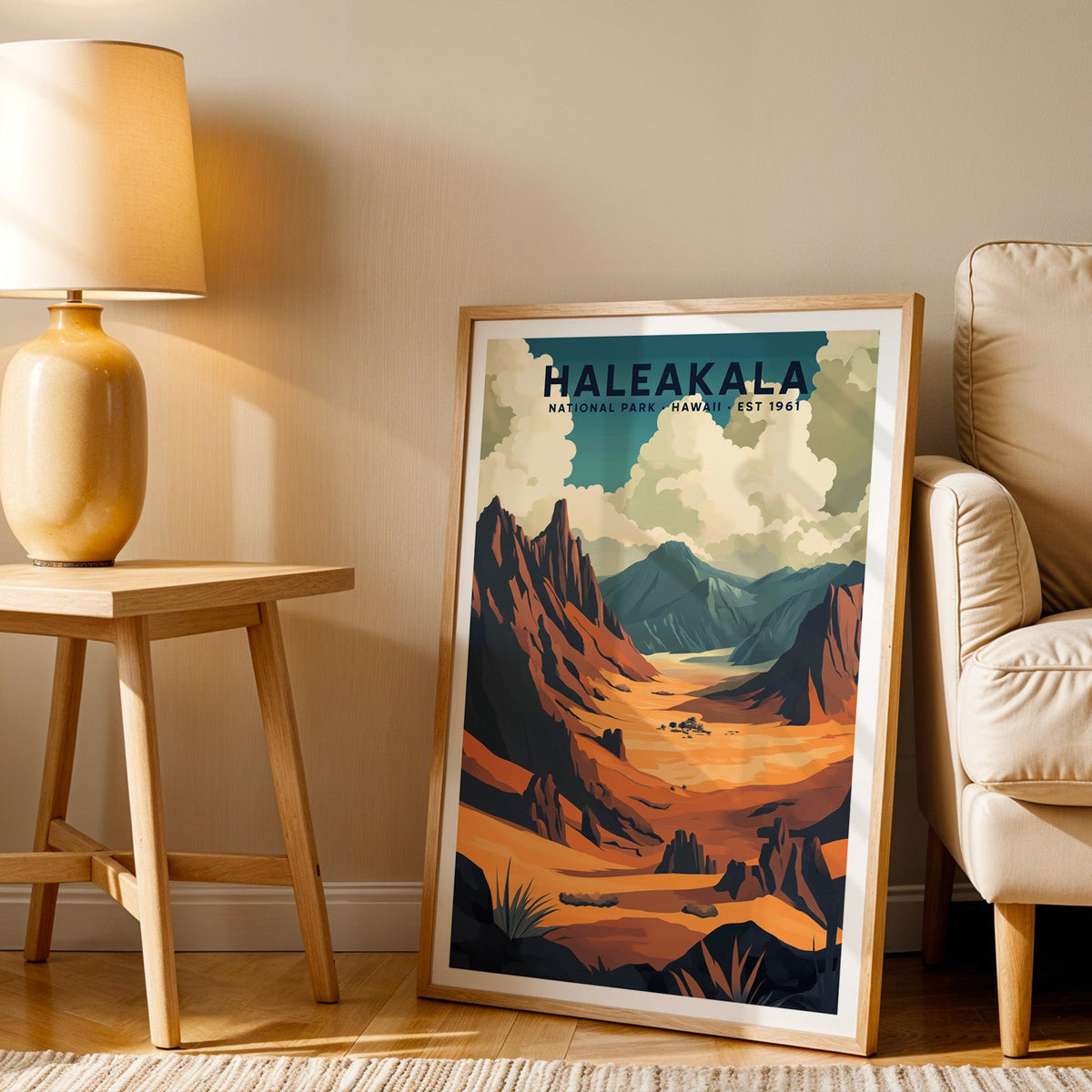 Haleakalā print in an oak frame beside a cream armchair and an amber lamp in warm light