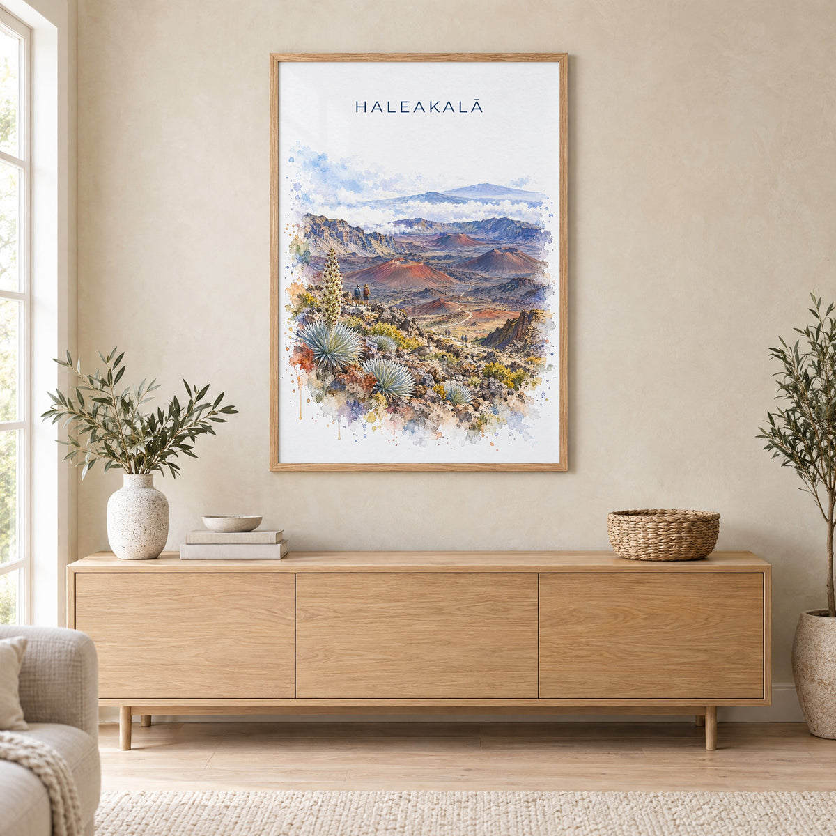 Haleakala National Park watercolor print in an oak frame above a light wood sideboard in a Scandinavian living room