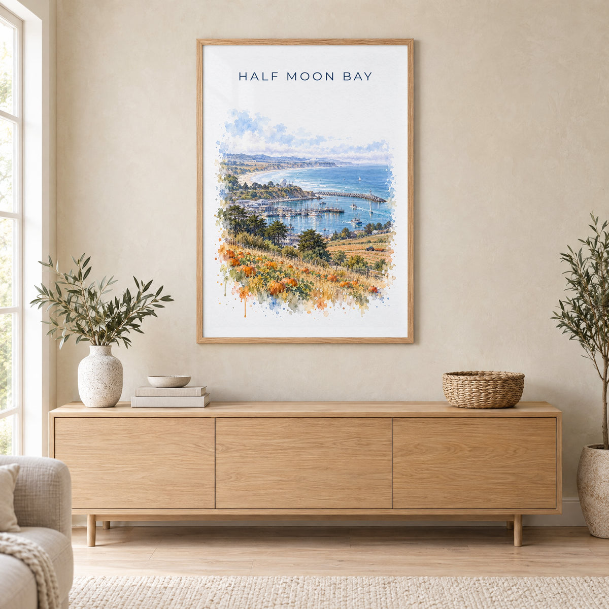 Half Moon Bay, California watercolor print in an oak frame above a light wood sideboard in a Scandinavian living room