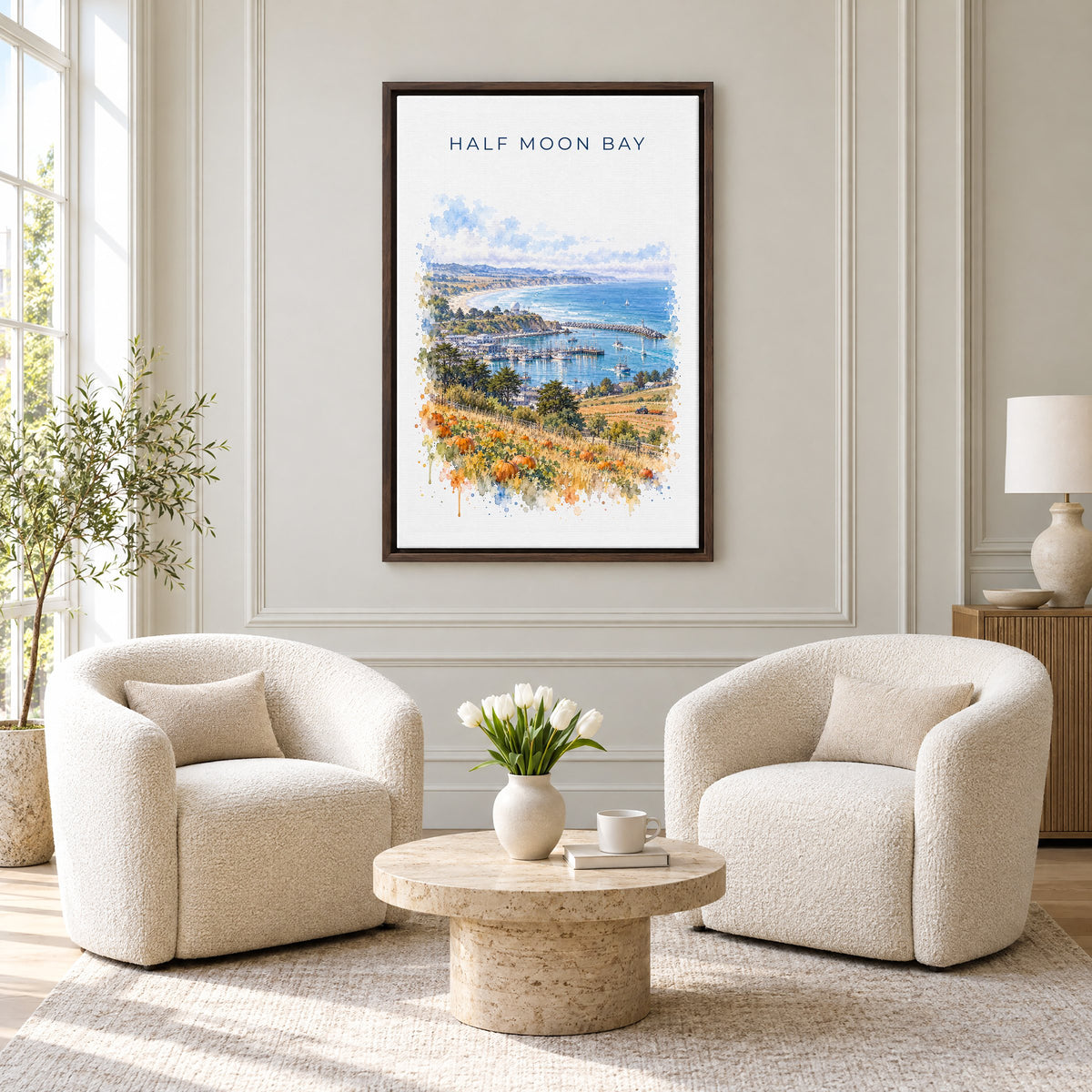 Half Moon Bay, California watercolor print as an espresso floater canvas above two boucle armchairs in a hotel lounge