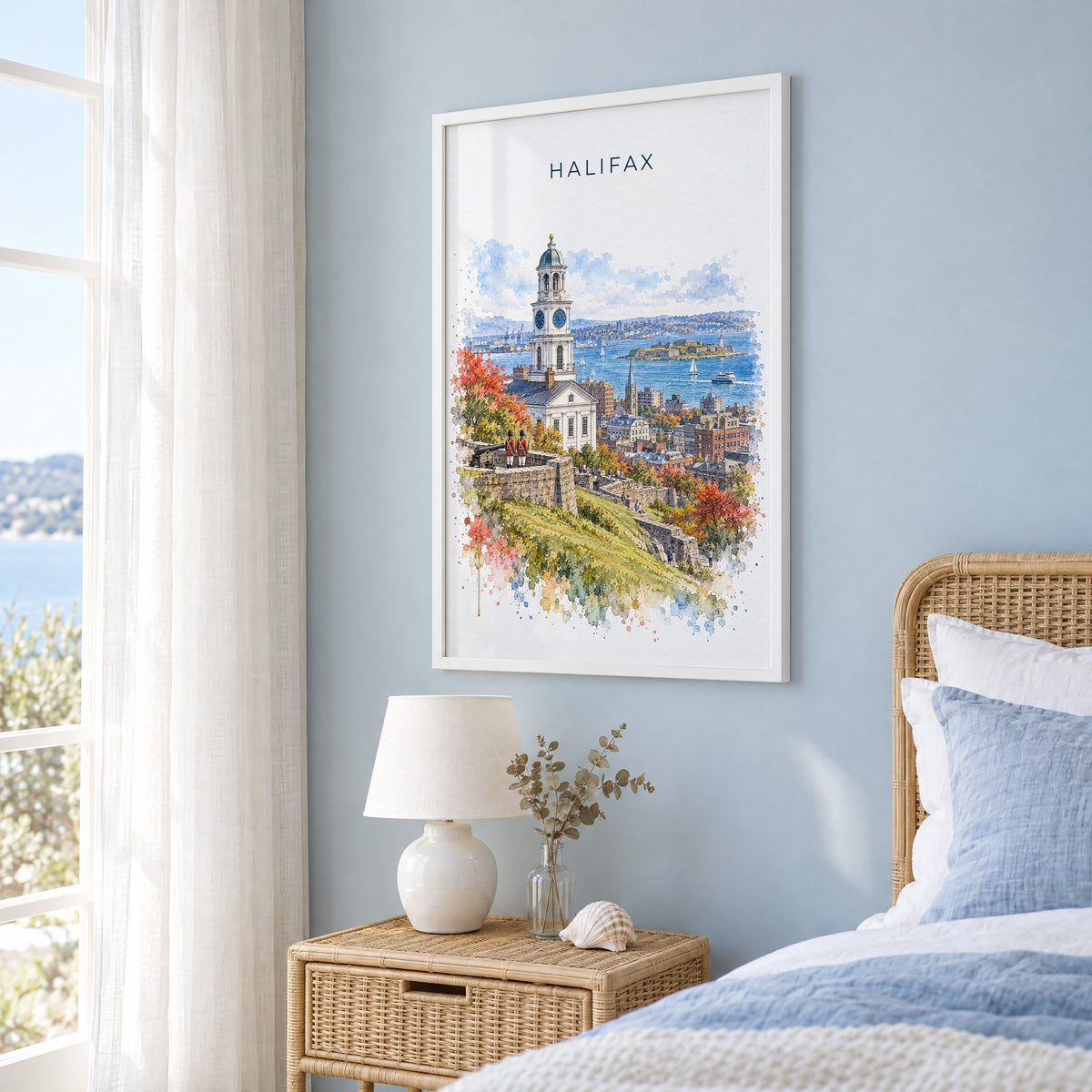 Halifax watercolor print in a white frame on a pale blue wall beside a rattan bed in a coastal bedroom