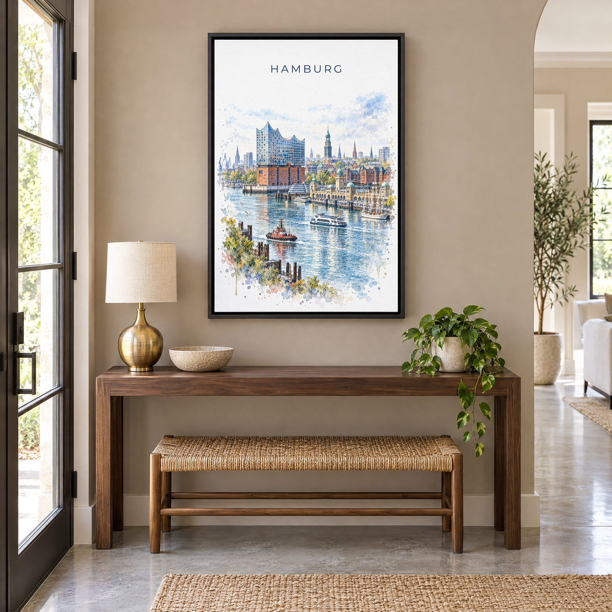 Hamburg watercolor print as a black floater canvas above a walnut console and woven bench in an entryway