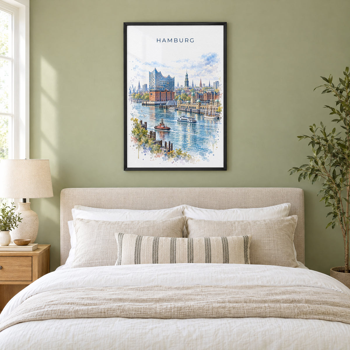 Hamburg watercolor print in a black frame above an upholstered headboard in a sage green bedroom
