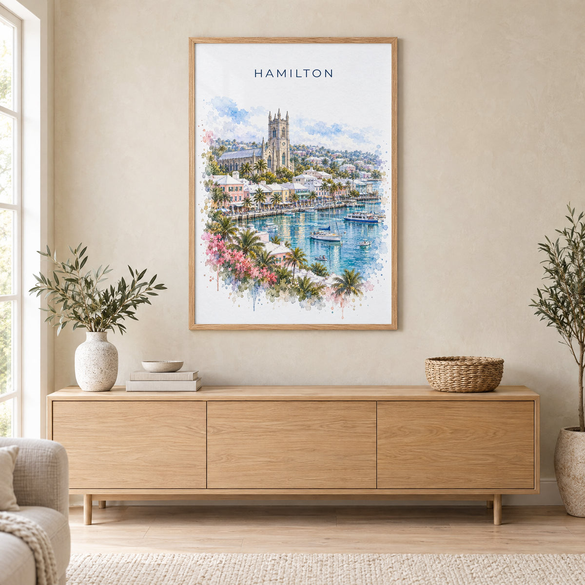 Hamilton, Bermuda watercolor print in an oak frame above a light wood sideboard in a Scandinavian living room