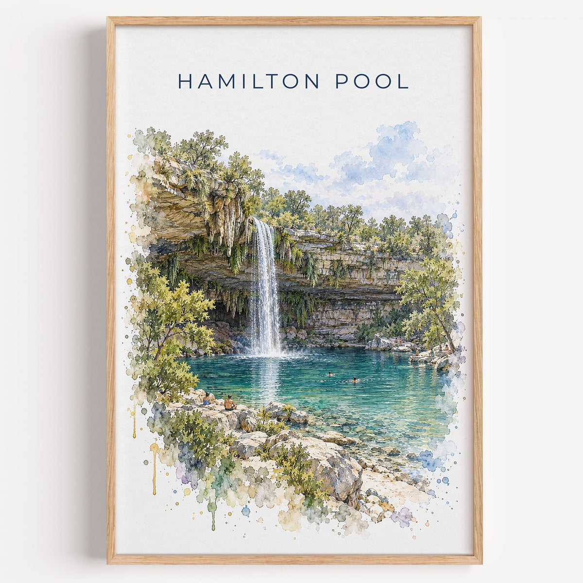 Hamilton Pool watercolor print in a light oak frame on a plain white wall