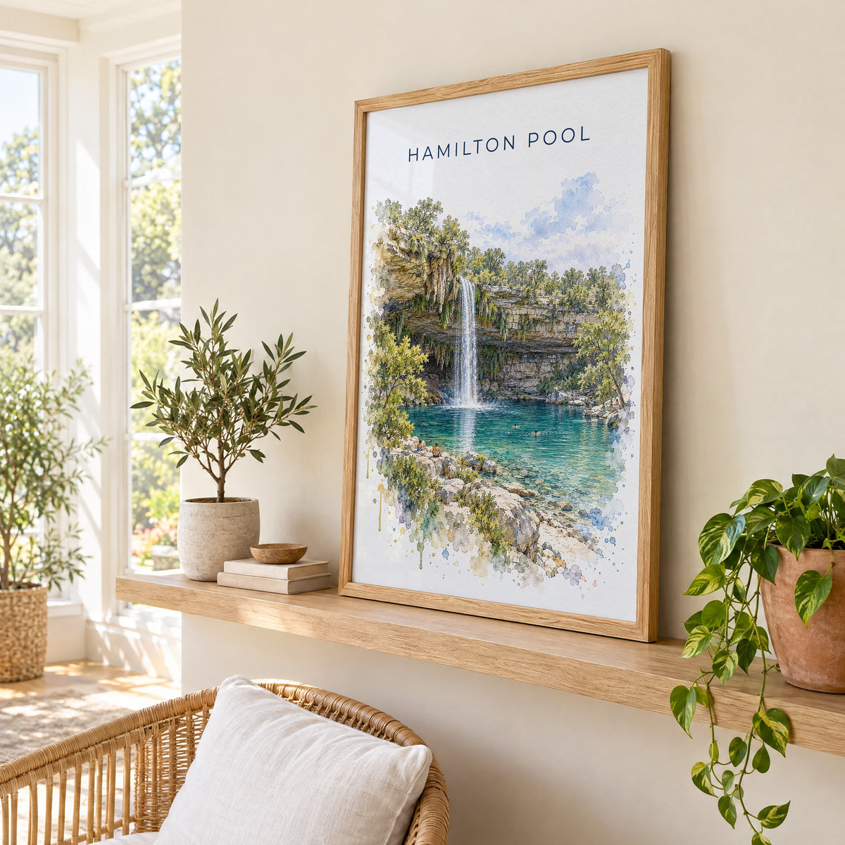 Hamilton Pool watercolor print in an oak frame on a picture ledge in a sunlit sunroom