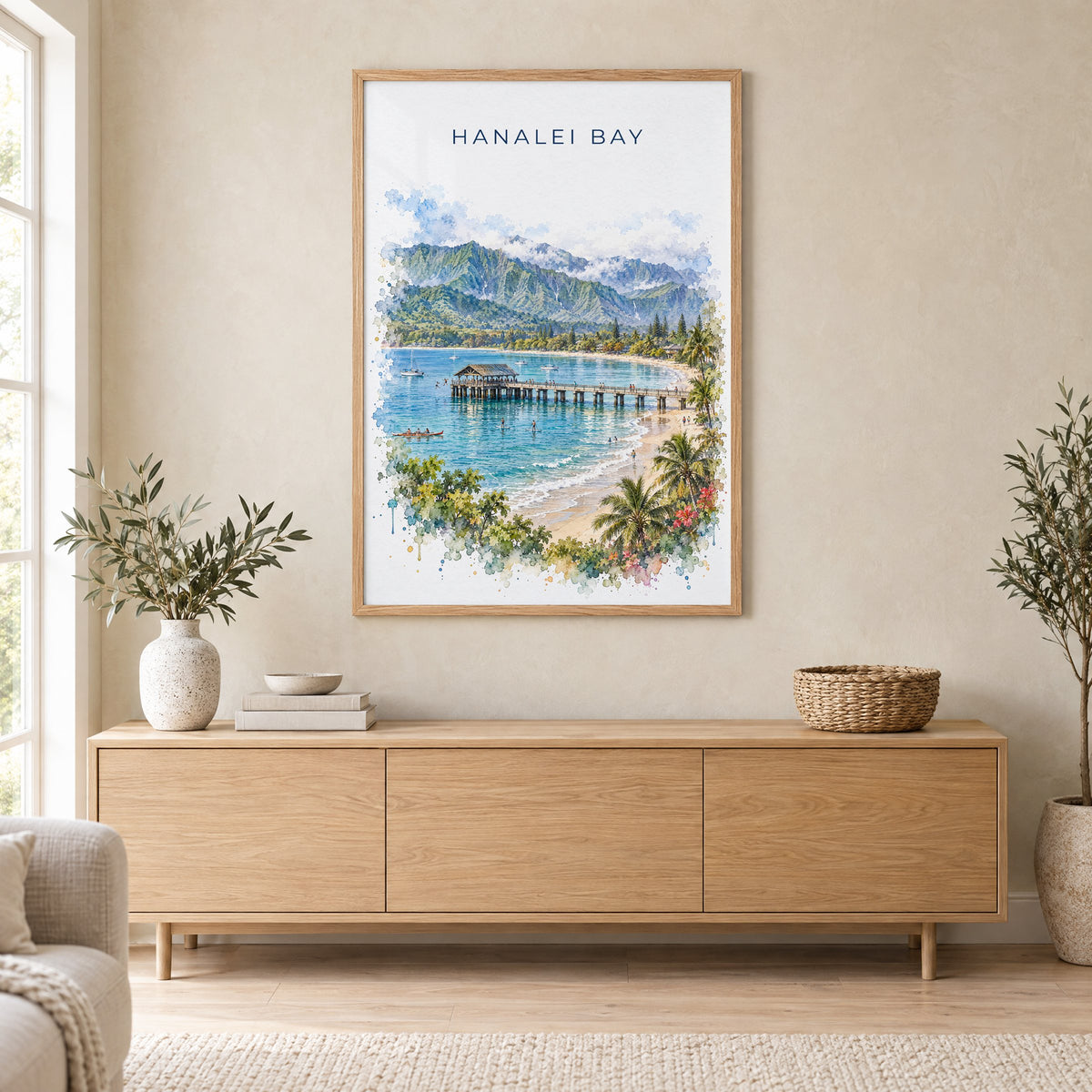 Hanalei Bay watercolor print in an oak frame above a light wood sideboard in a Scandinavian living room