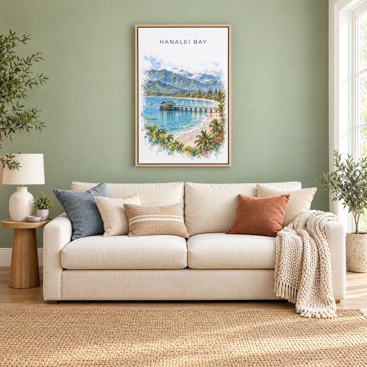 Hanalei Bay watercolor print as a natural floater canvas above a cream linen sofa on a sage green wall