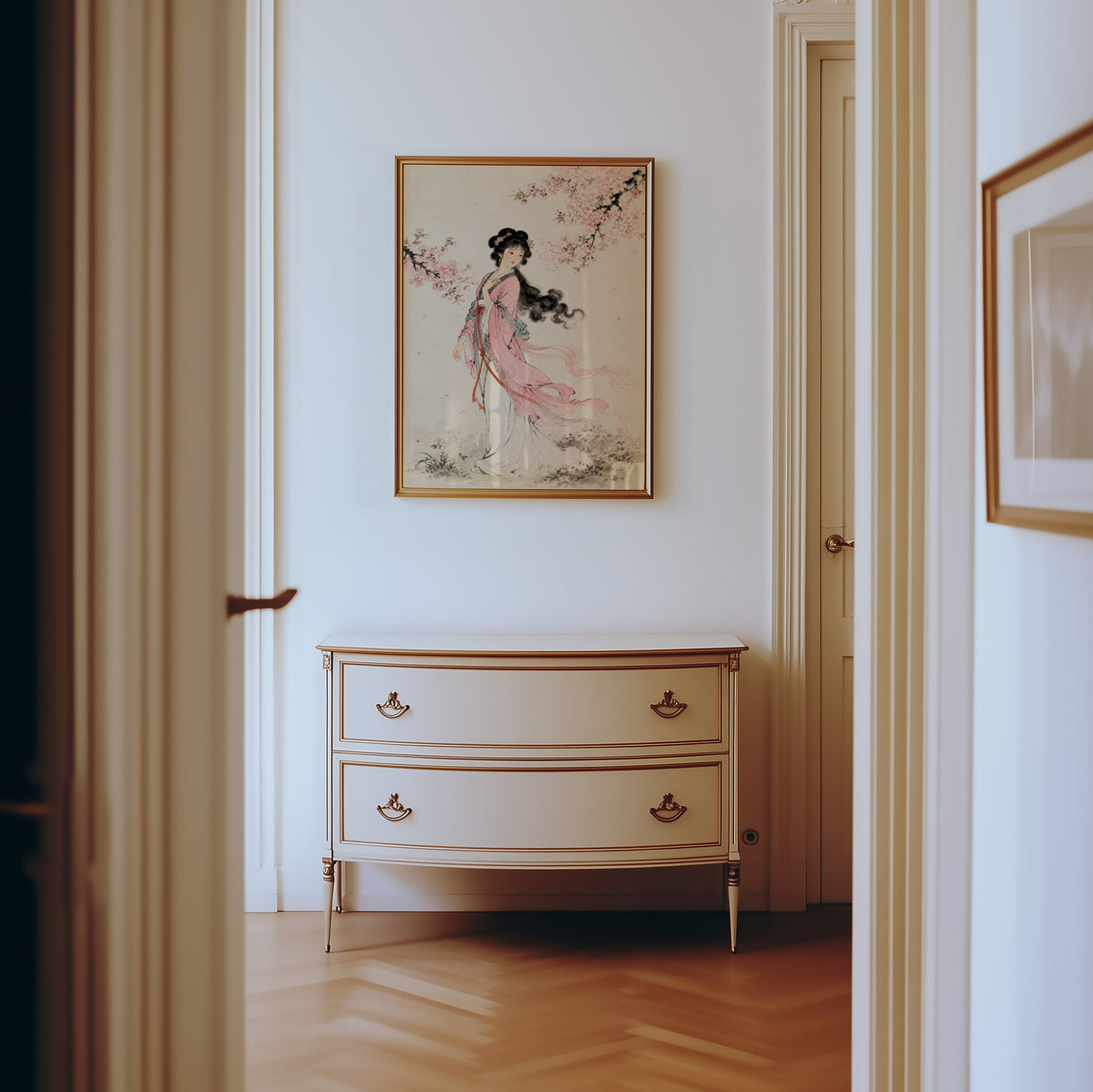 woman in pink hanfu under blossom print shown in a gold frame in a hallway above a cream dresser