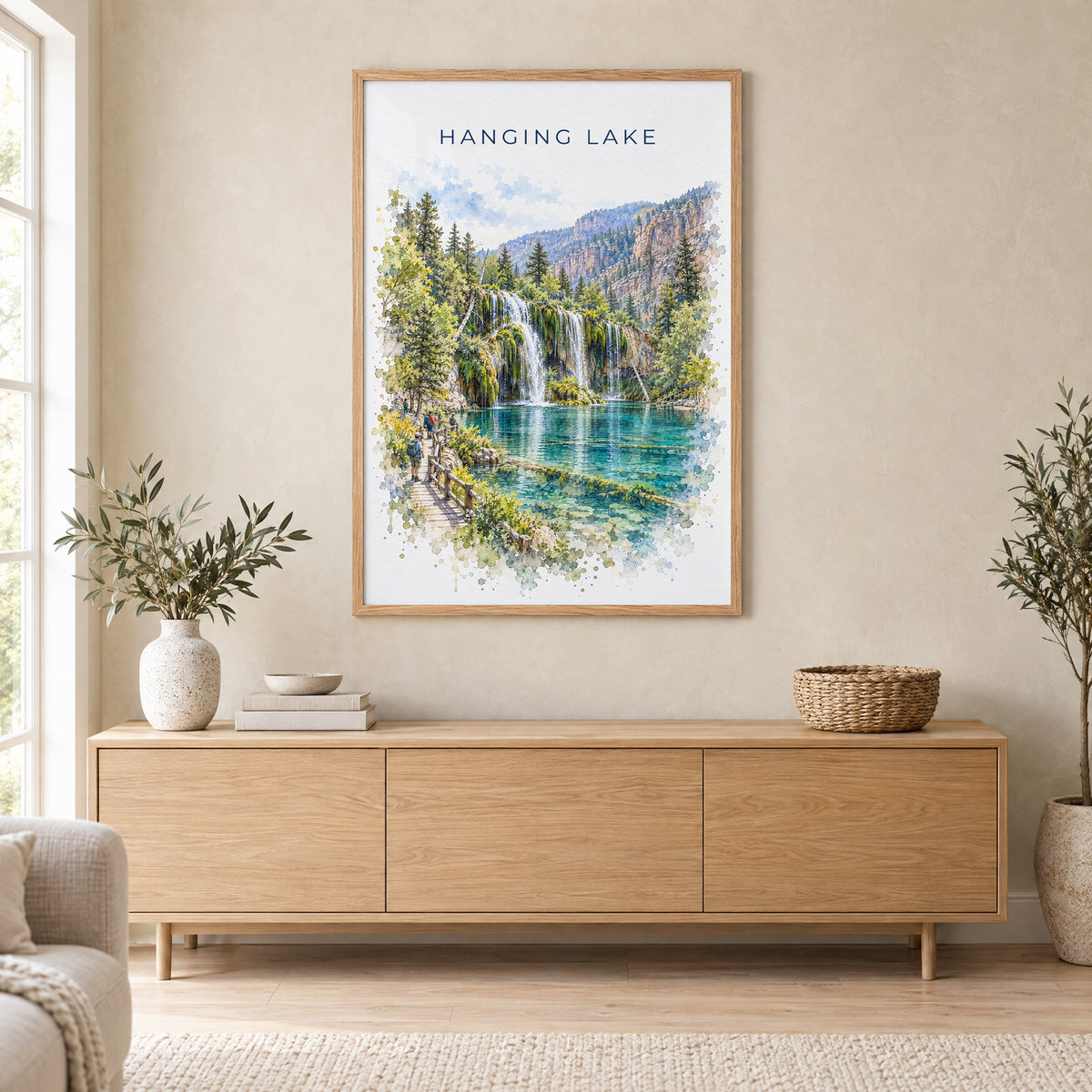 Hanging Lake watercolor print in an oak frame above a light wood sideboard in a Scandinavian living room