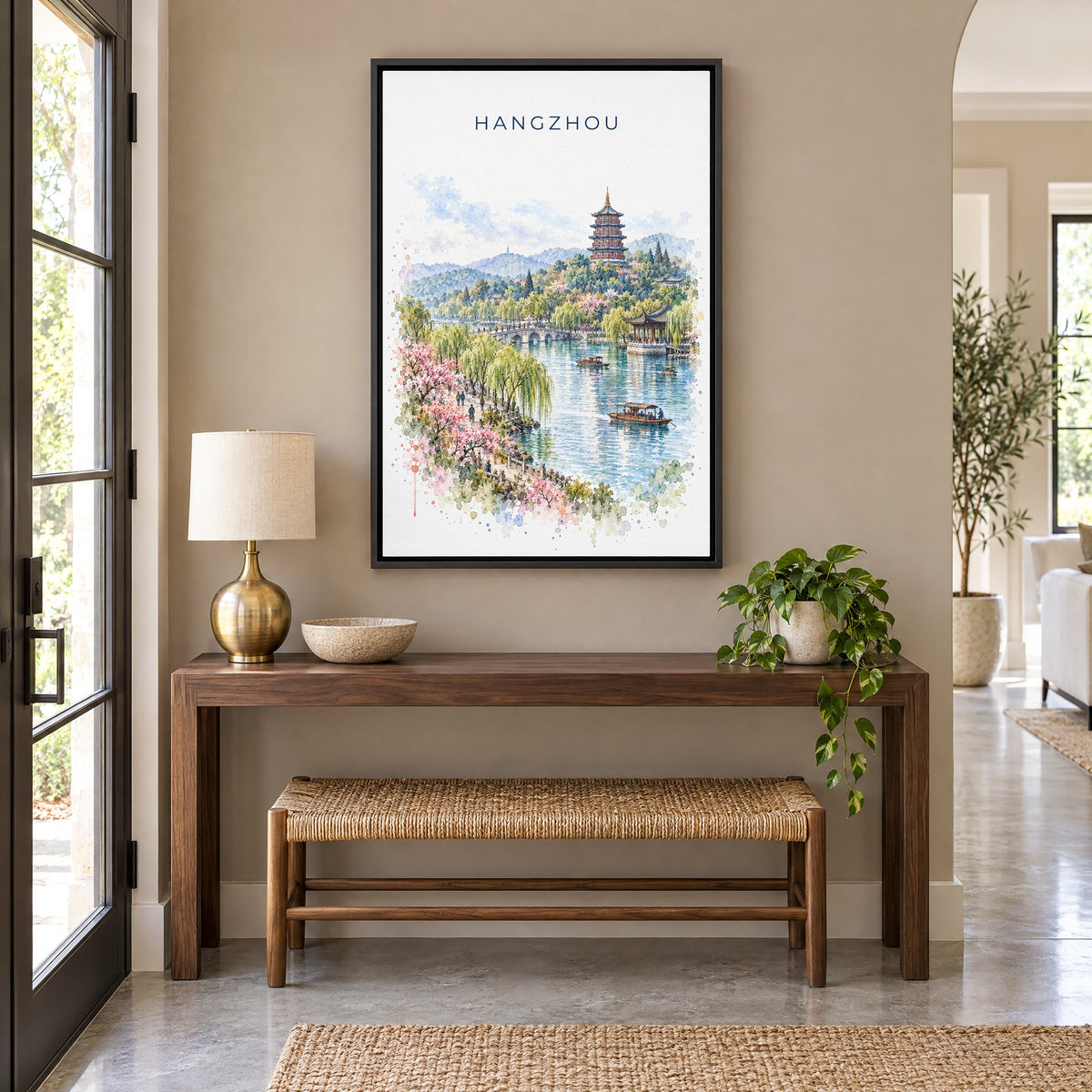 Hangzhou watercolor print as a black floater canvas above a walnut console and woven bench in an entryway