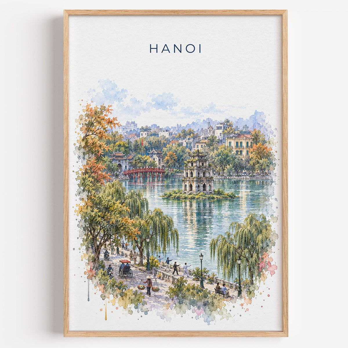 Hanoi watercolor print in a light oak frame on a plain white wall