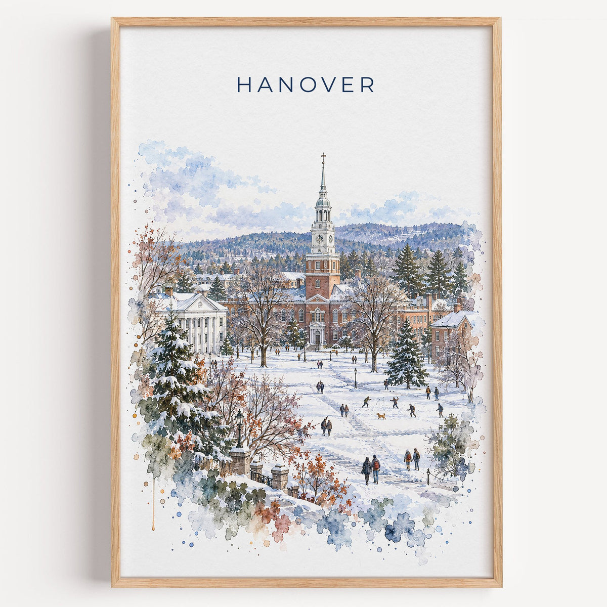 Hanover, New Hampshire watercolor print in a light oak frame on a plain white wall