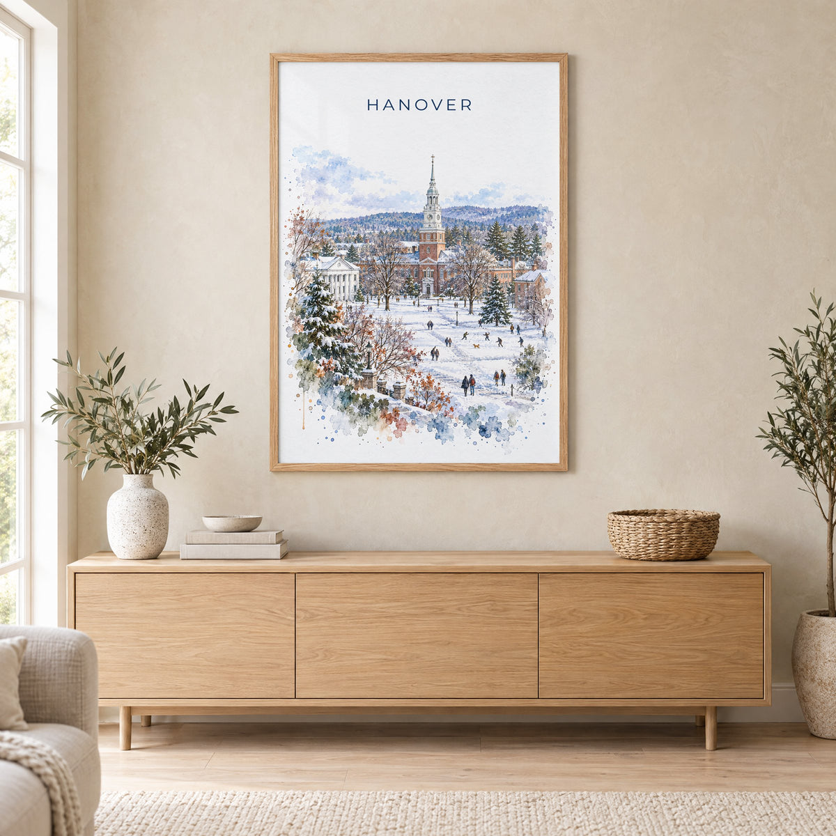 Hanover, New Hampshire watercolor print in an oak frame above a light wood sideboard in a Scandinavian living room