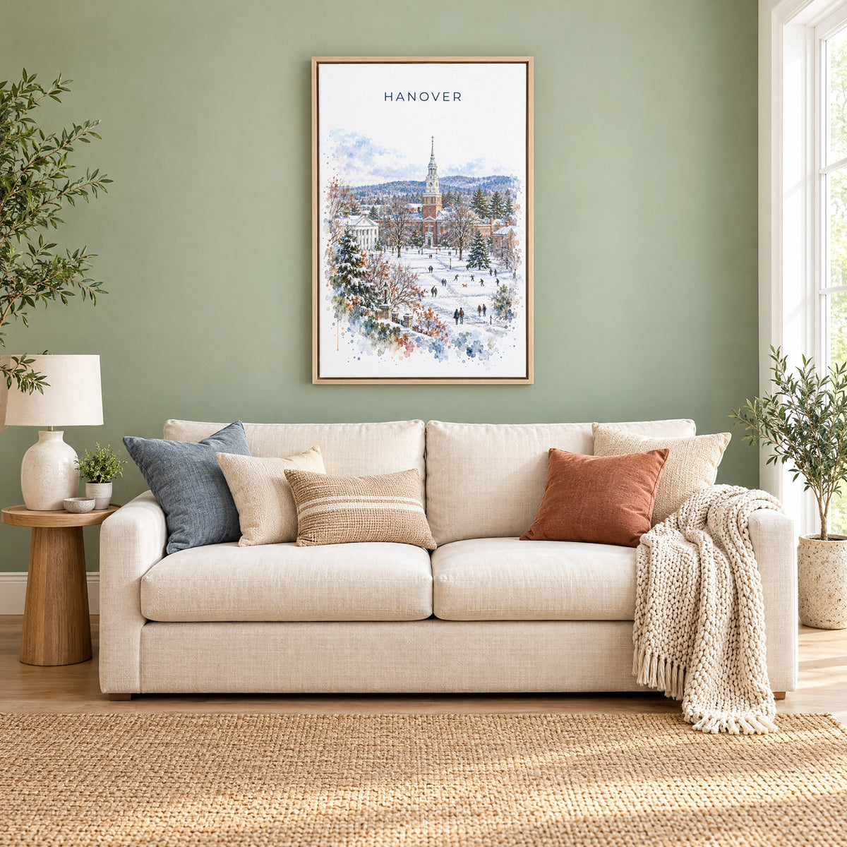 Hanover, New Hampshire watercolor print as a natural floater canvas above a cream linen sofa on a sage green wall