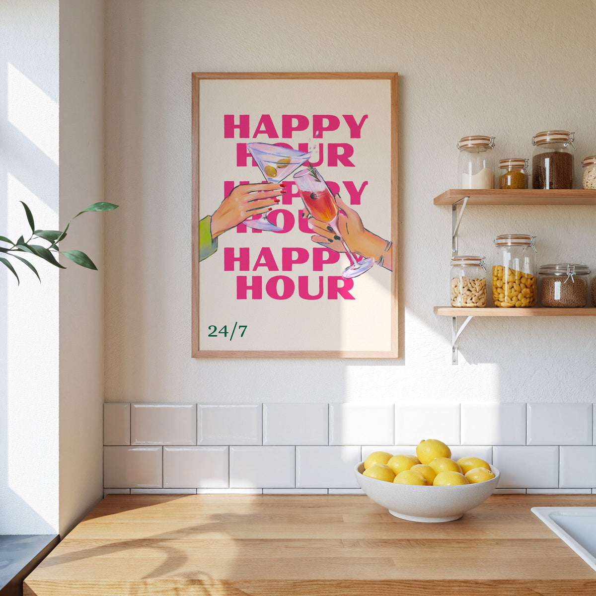 Happy Hour repeat toast print in an oak frame on a subway-tiled kitchen wall beside open shelves of pantry jars