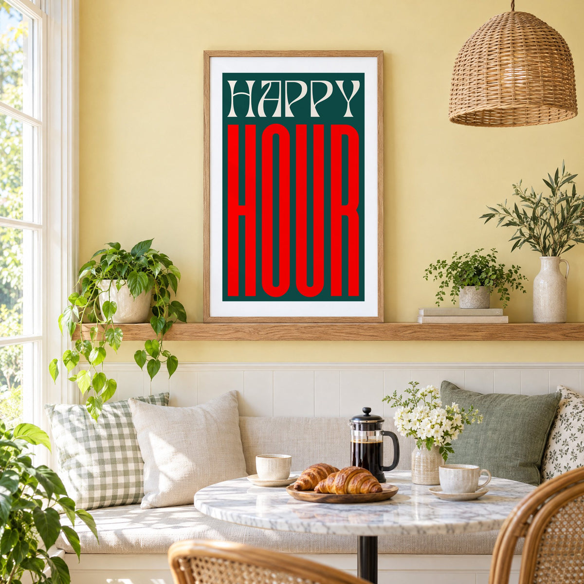 Happy Hour red and teal type print in an oak frame on a picture ledge above a sunny breakfast nook