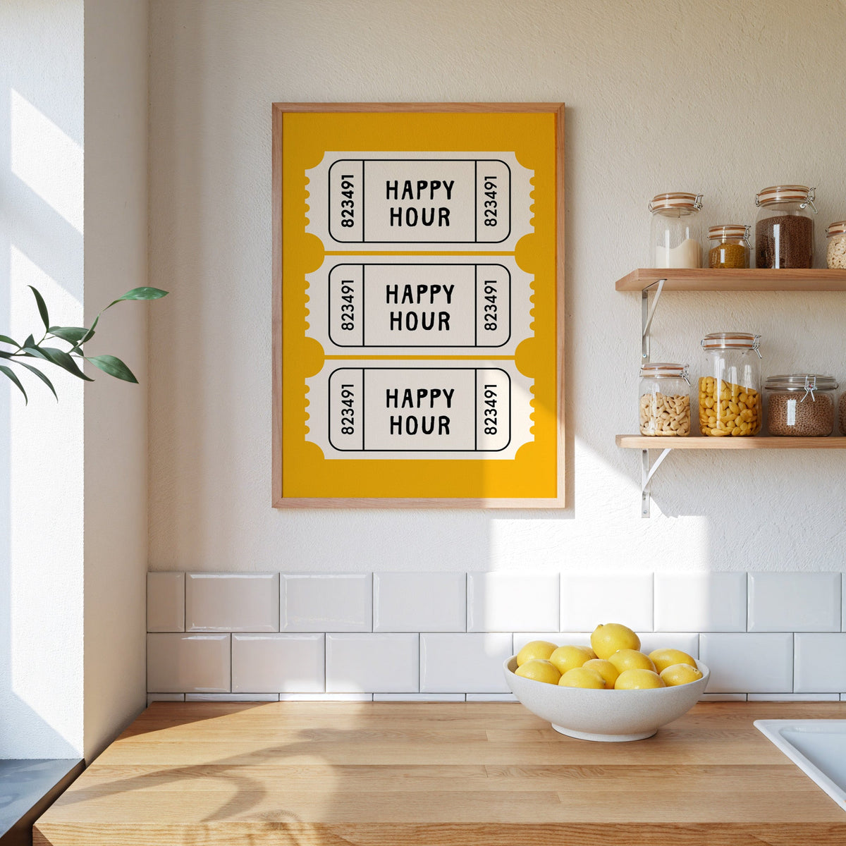 Happy Hour yellow tickets print in an oak frame on a subway-tiled kitchen wall beside open shelves of pantry jars