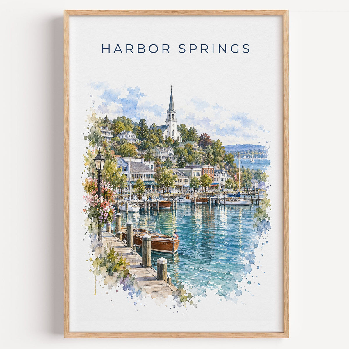 Harbor Springs, Michigan watercolor print in a light oak frame on a plain white wall