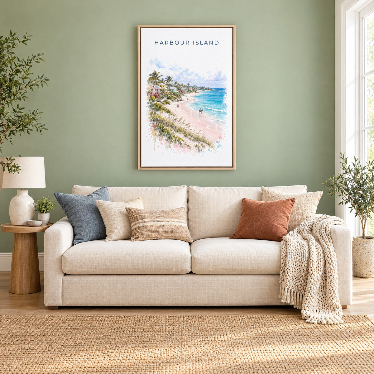 Harbour Island watercolor print as a natural floater canvas above a cream linen sofa on a sage green wall
