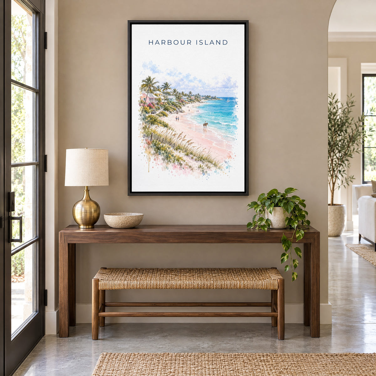 Harbour Island watercolor print as a black floater canvas above a walnut console and woven bench in an entryway