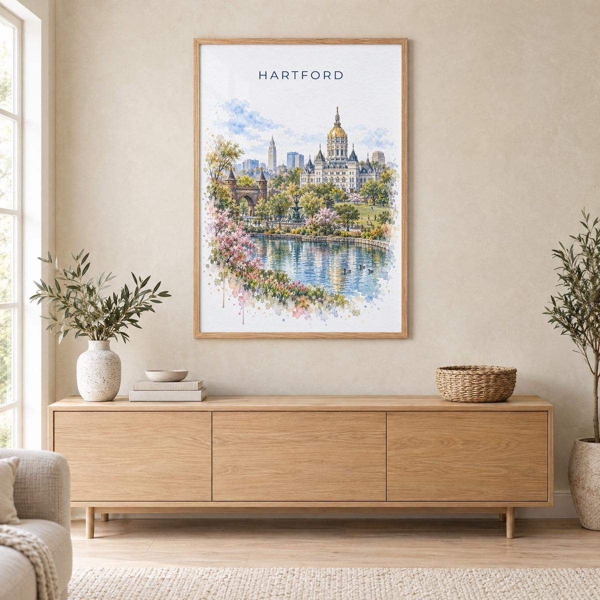 Hartford, Connecticut watercolor print in an oak frame above a light wood sideboard in a Scandinavian living room