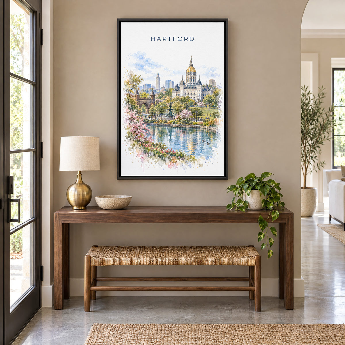 Hartford, Connecticut watercolor print as a black floater canvas above a walnut console and woven bench in an entryway