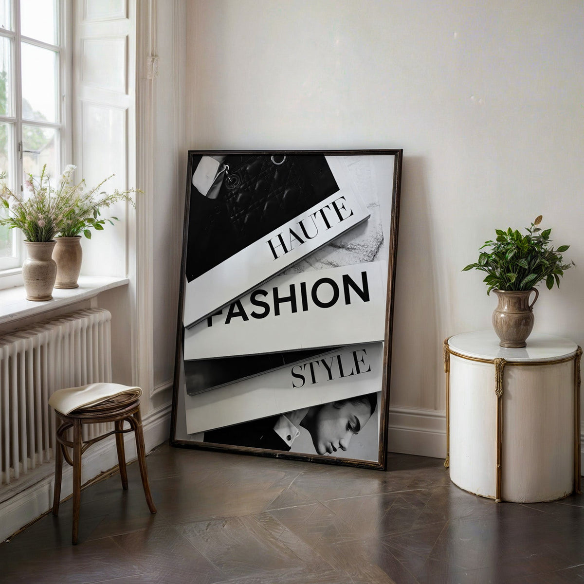 Stacked HAUTE FASHION STYLE books flat lay print in a black frame on a dark stone floor beside a white side table