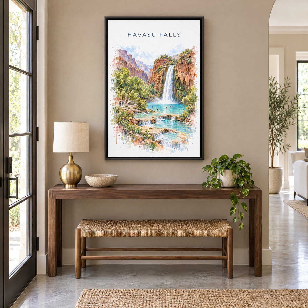 Havasu Falls watercolor print as a black floater canvas above a walnut console and woven bench in an entryway