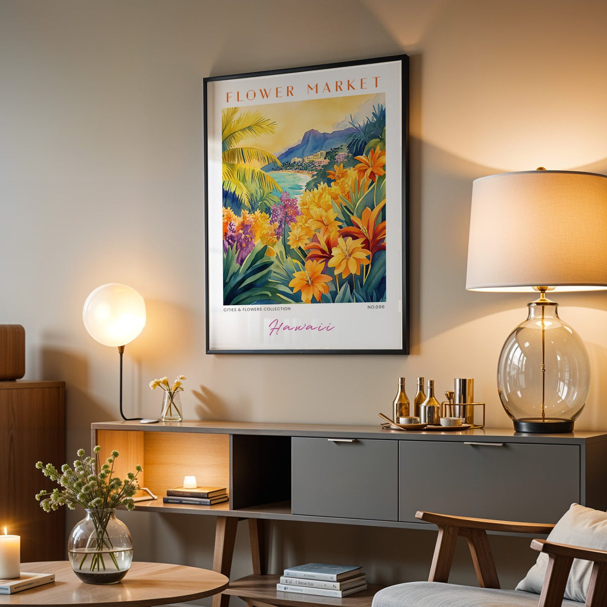 Hawaii flower market print in a black frame above a grey media console with a glass table lamp