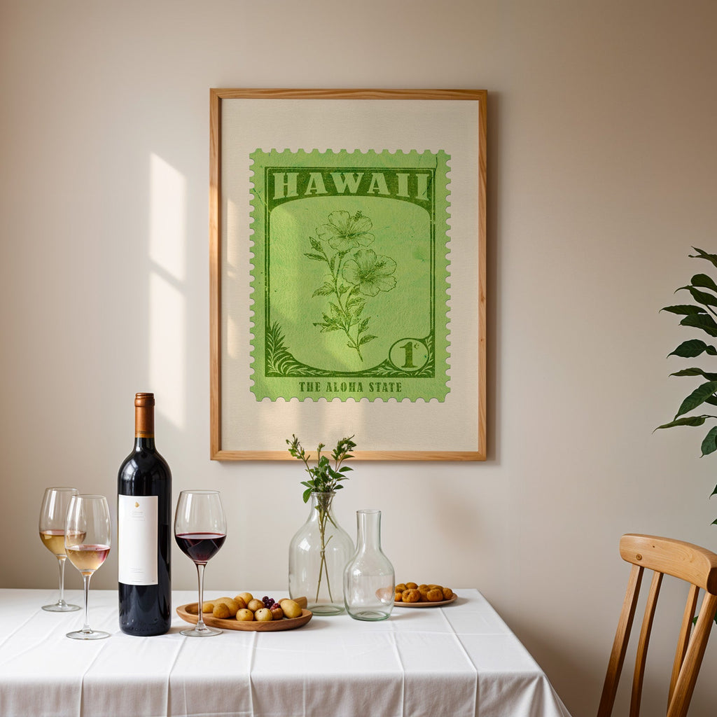 Hawaii stamp print framed on the wall above a dining table set with wine, glasses and olives