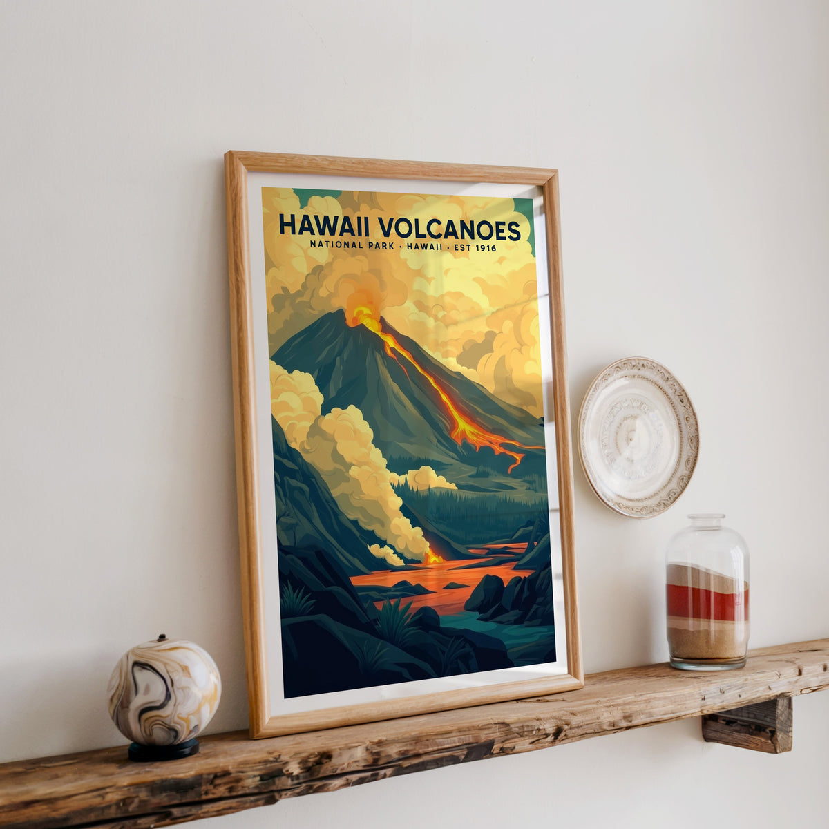 Hawaiʻi Volcanoes print in an oak frame on a rustic wood shelf with ceramics and a jar