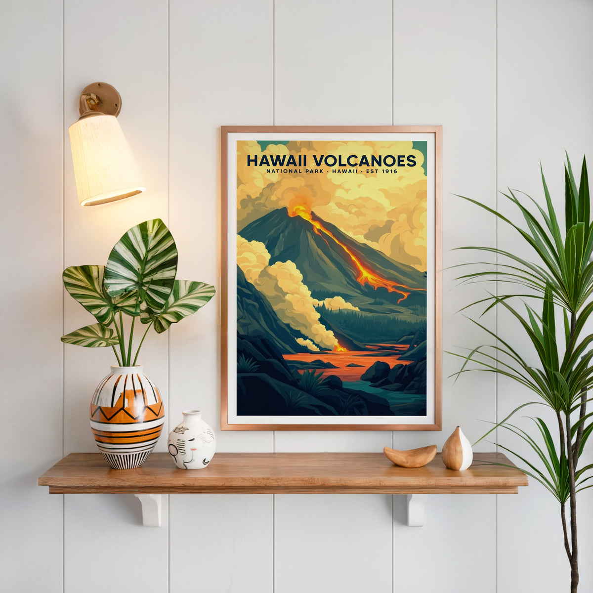 Hawaiʻi Volcanoes print in a copper frame above an oak shelf on white shiplap with a sconce