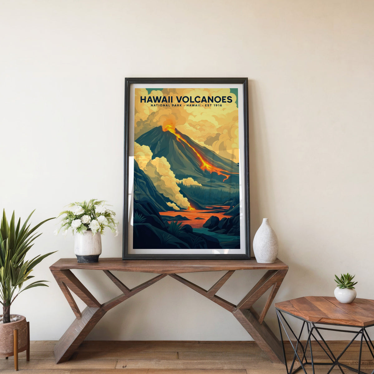 Hawaiʻi Volcanoes poster in a black frame on an entryway console table with white flowers