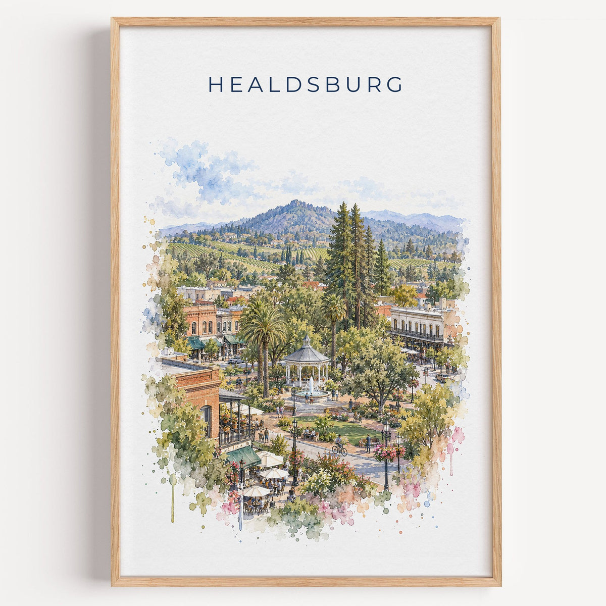 Healdsburg, California watercolor print in a light oak frame on a plain white wall