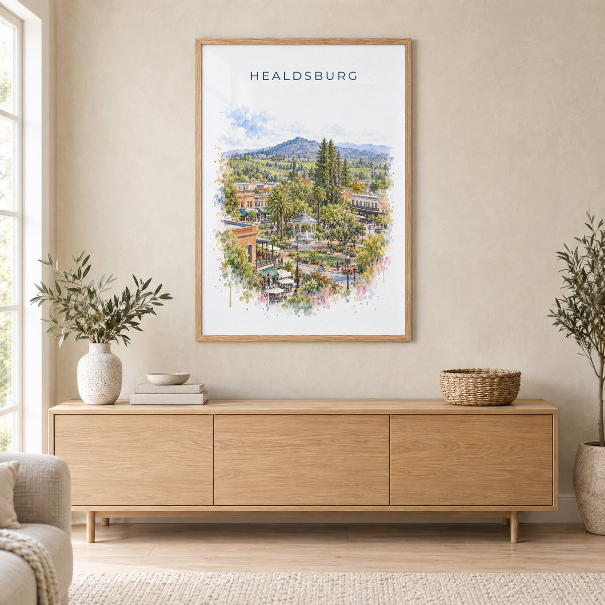 Healdsburg, California watercolor print in an oak frame above a light wood sideboard in a Scandinavian living room