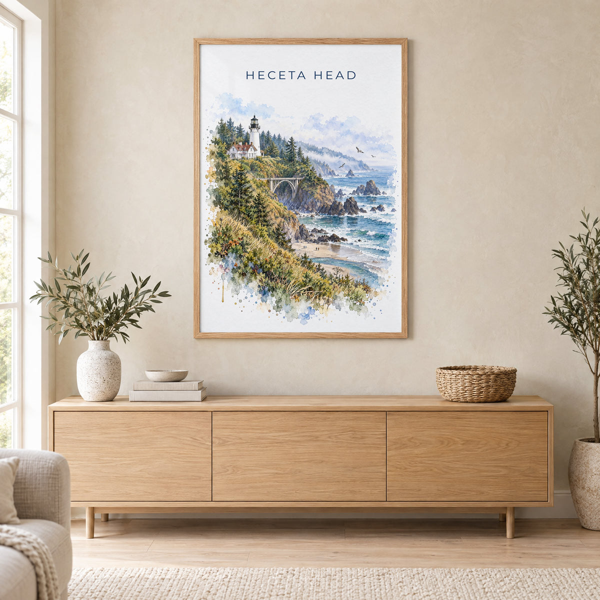 Heceta Head watercolor print in an oak frame above a light wood sideboard in a Scandinavian living room