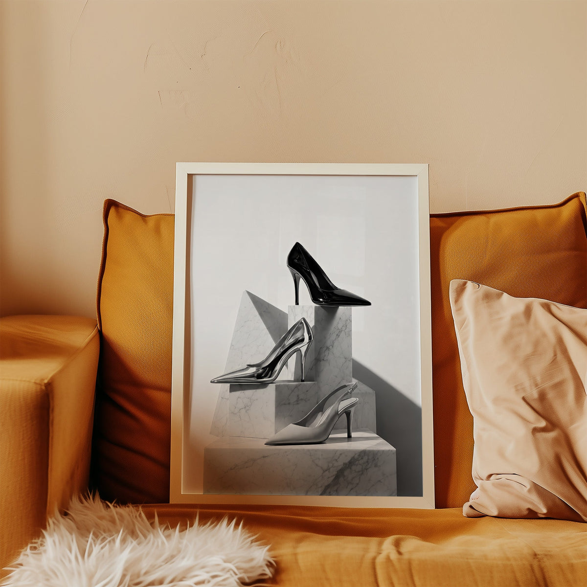 Three pairs of heels on marble pedestals print in a white frame leaning on a mustard velvet sofa