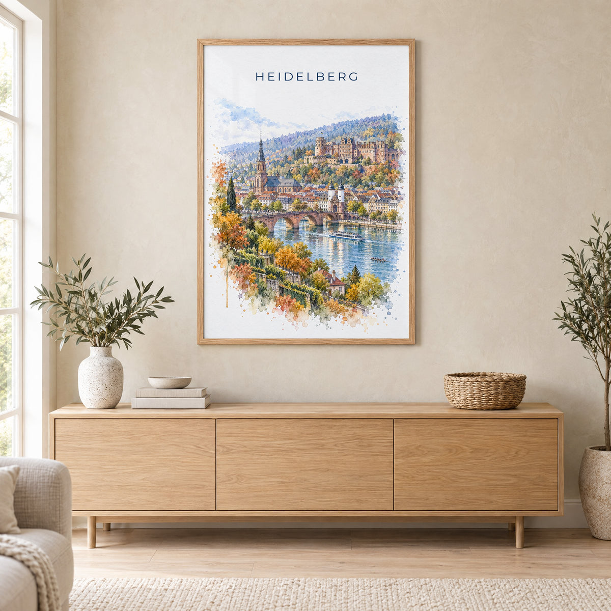 Heidelberg watercolor print in an oak frame above a light wood sideboard in a Scandinavian living room
