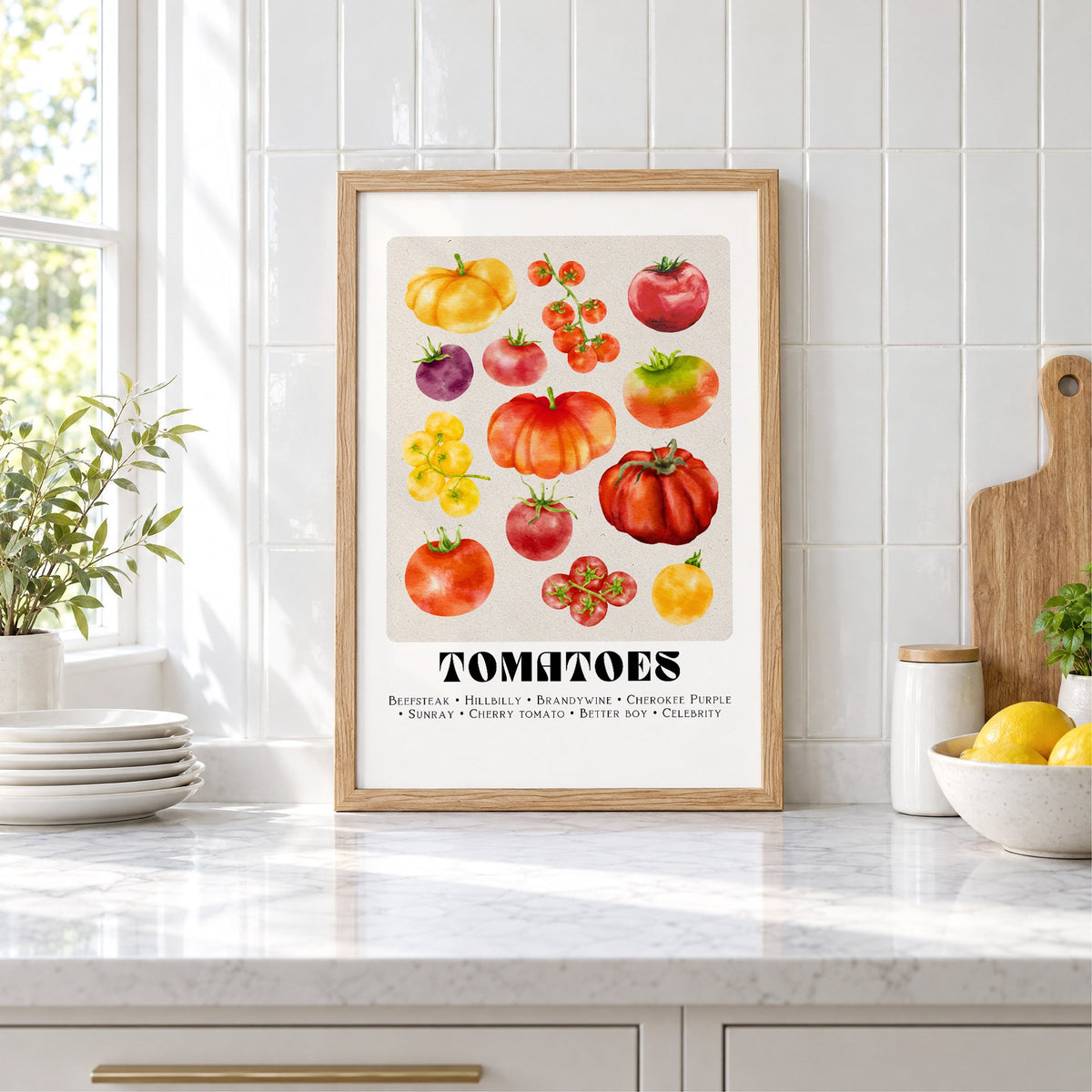 Tomato varieties watercolor print in an oak frame leaning on a marble counter by white tiles and lemons
