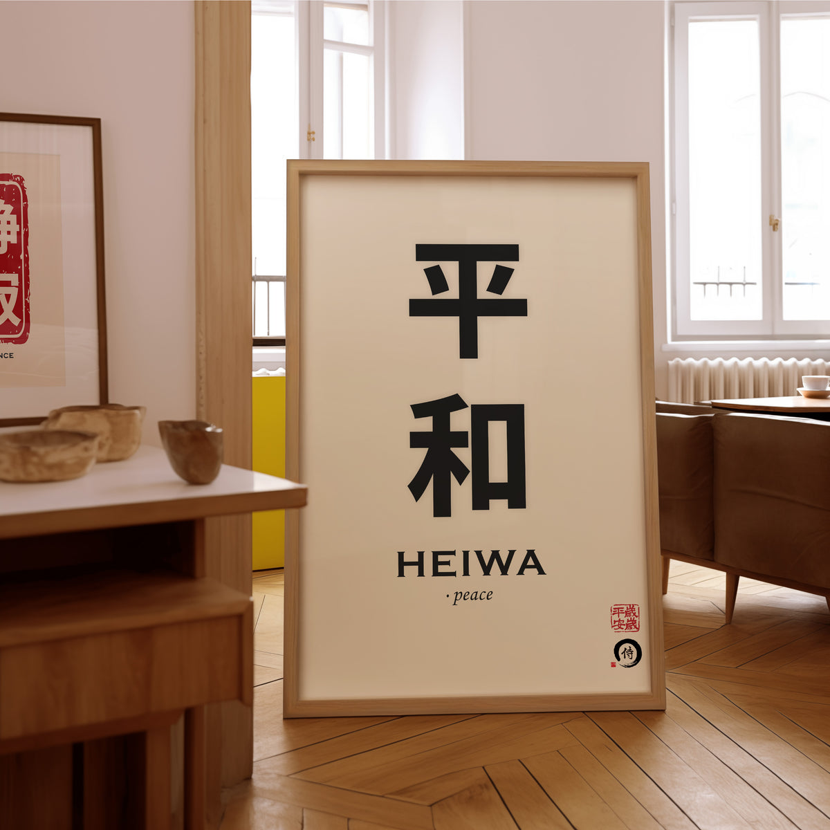 Heiwa peace kanji calligraphy print in an oak frame on the parquet floor of a sunlit living room