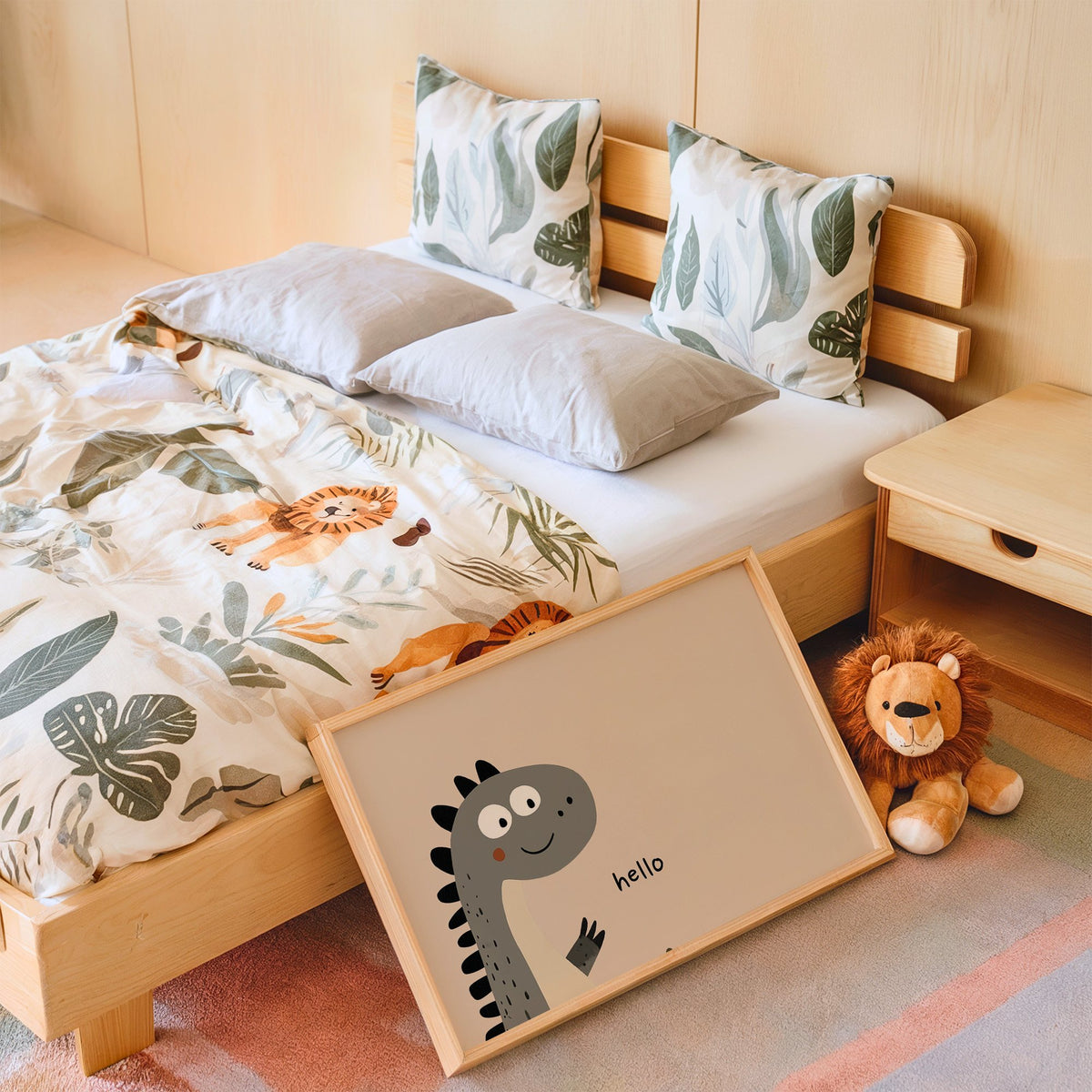 Landscape hello peeking dinosaur nursery print in an oak frame leaning on a kids bed by a lion plush