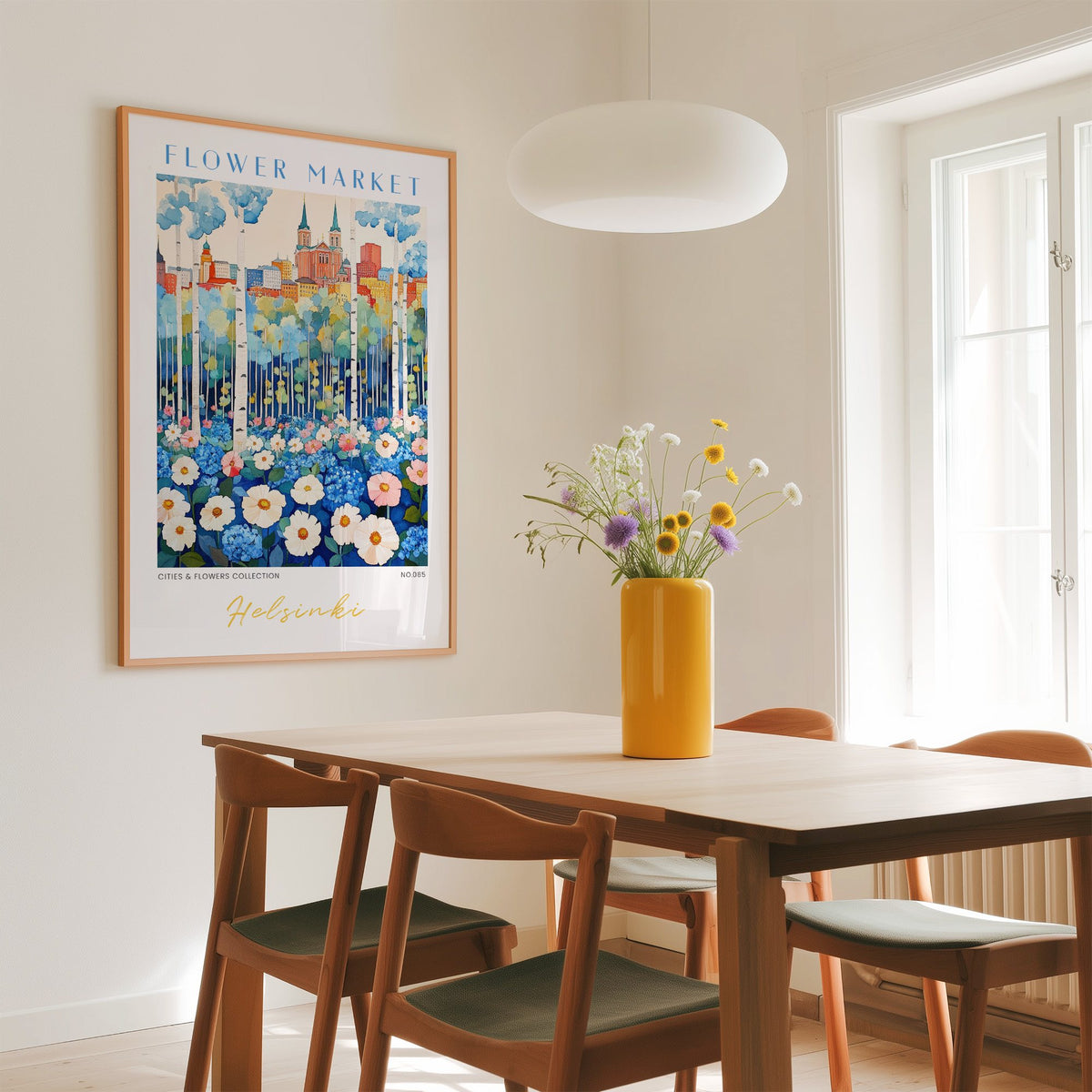 Helsinki flower market print in an oak frame above a dining table with a yellow vase and white pendant light