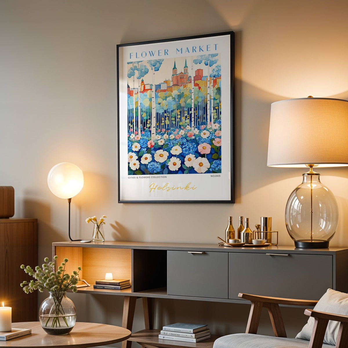 Helsinki flower market print in a black frame above a grey media console with a glass table lamp