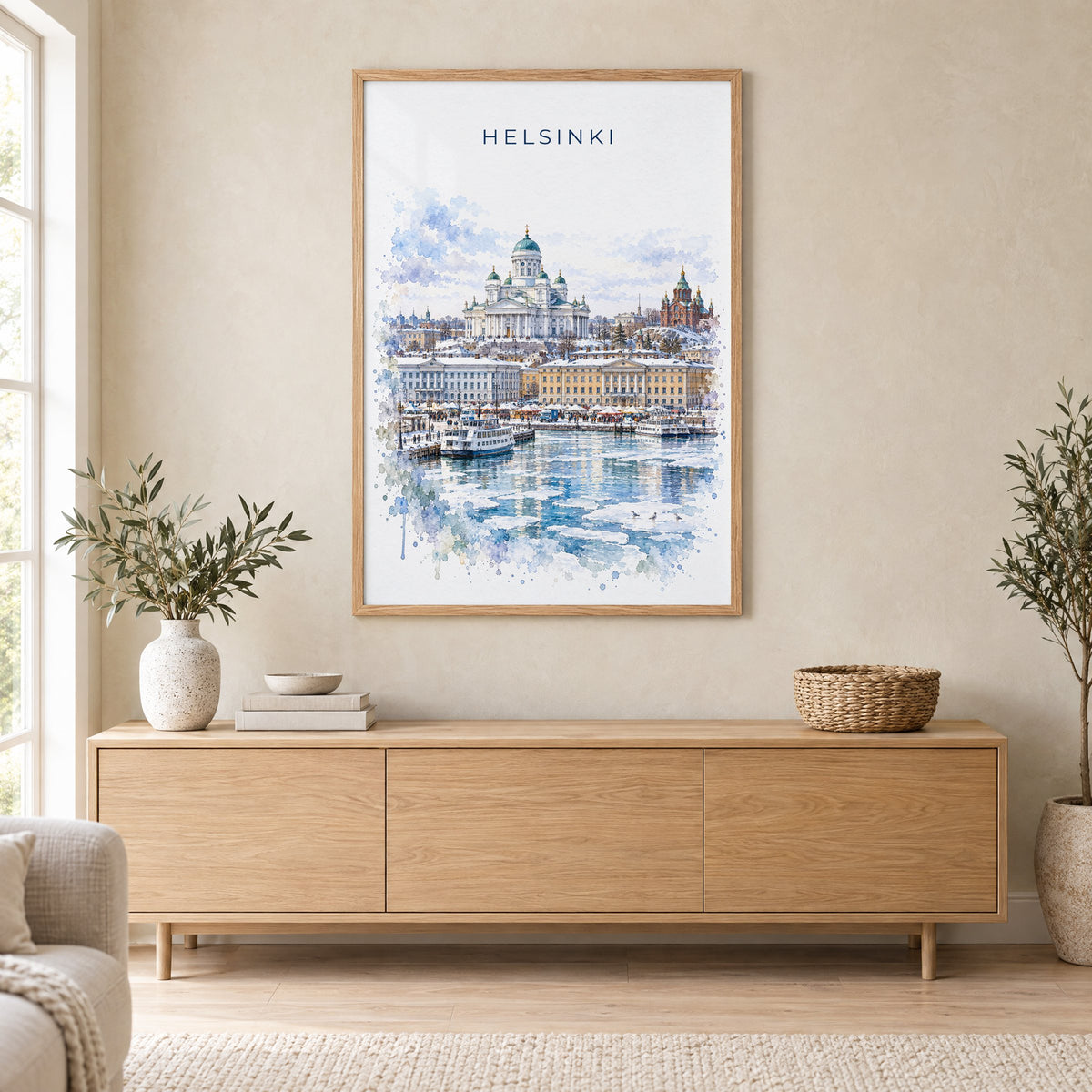 Helsinki watercolor print in an oak frame above a light wood sideboard in a Scandinavian living room
