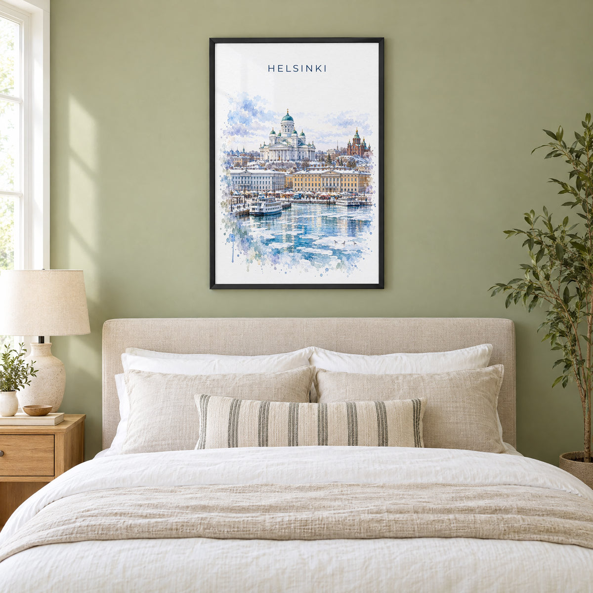 Helsinki watercolor print in a black frame above an upholstered headboard in a sage green bedroom